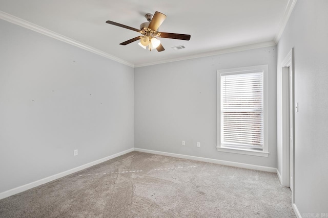 carpeted spare room featuring ceiling fan and crown molding