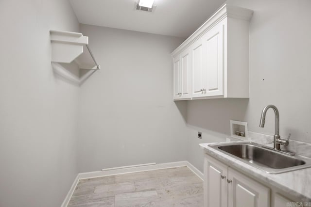 laundry room with sink, electric dryer hookup, hookup for a washing machine, and cabinets