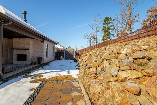 view of home's exterior with a patio area and a storage shed