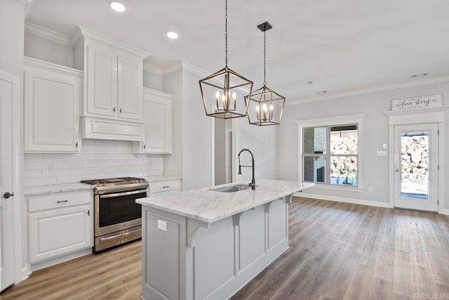 kitchen featuring white cabinets, stainless steel gas range, and sink