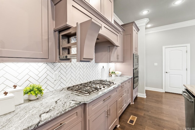 kitchen with stainless steel appliances, ornamental molding, backsplash, light stone countertops, and dark wood-type flooring