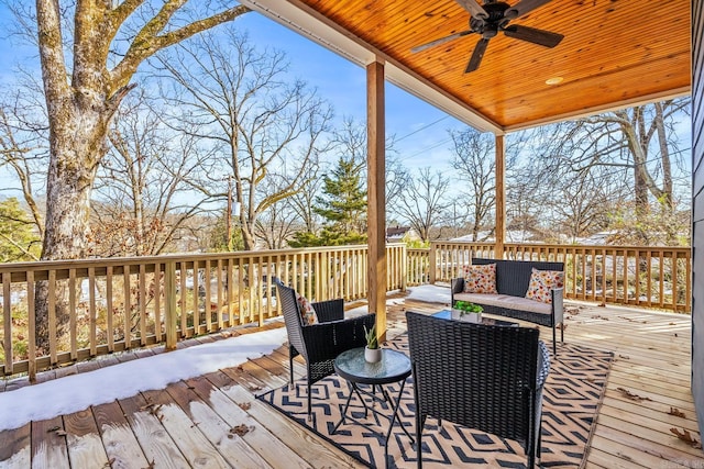 wooden deck with ceiling fan and an outdoor living space