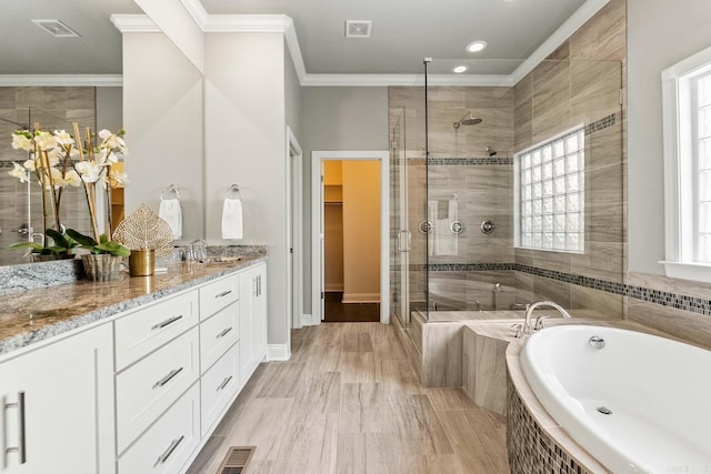 bathroom with separate shower and tub, crown molding, and vanity