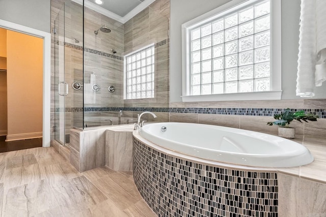 bathroom featuring ornamental molding, plus walk in shower, and plenty of natural light