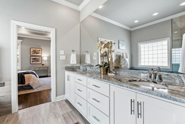 bathroom featuring ornamental molding and vanity