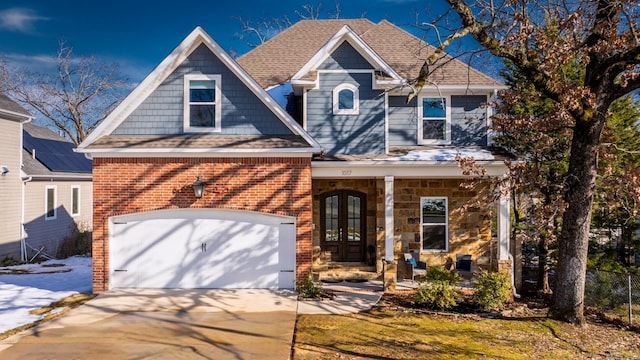 view of front of home with a porch, french doors, and a garage