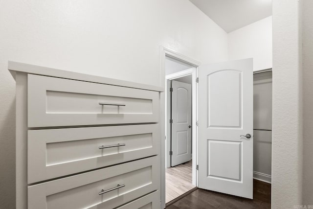 walk in closet with dark hardwood / wood-style flooring