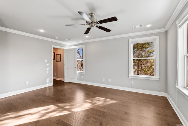 spare room featuring dark hardwood / wood-style flooring, ceiling fan, and crown molding