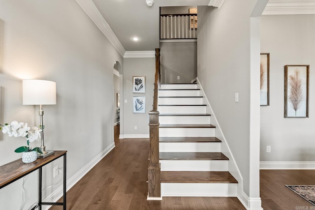 stairway featuring crown molding and wood-type flooring