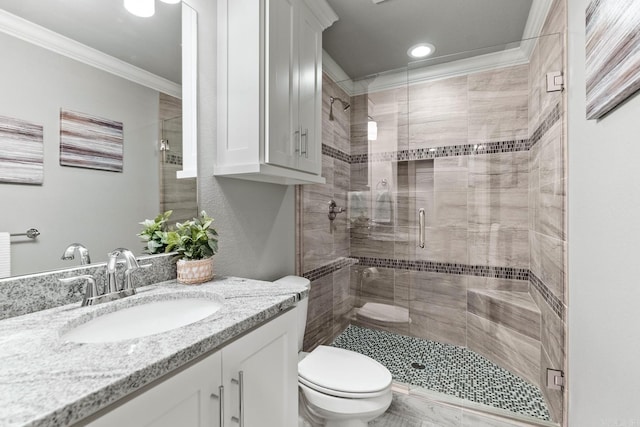 bathroom featuring toilet, ornamental molding, a shower with shower door, and vanity