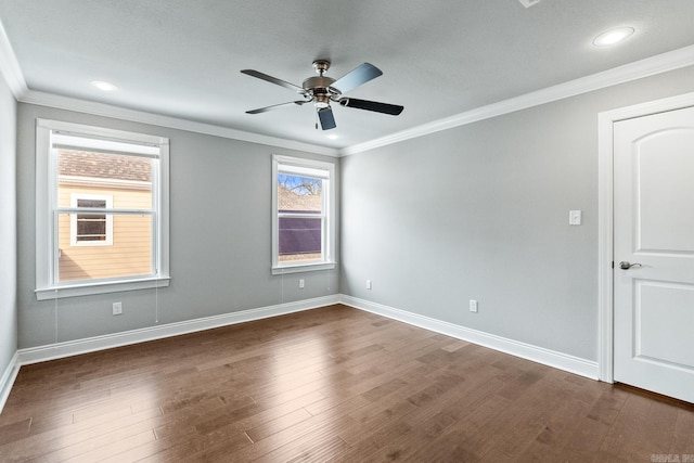 empty room featuring ornamental molding, dark hardwood / wood-style flooring, and ceiling fan