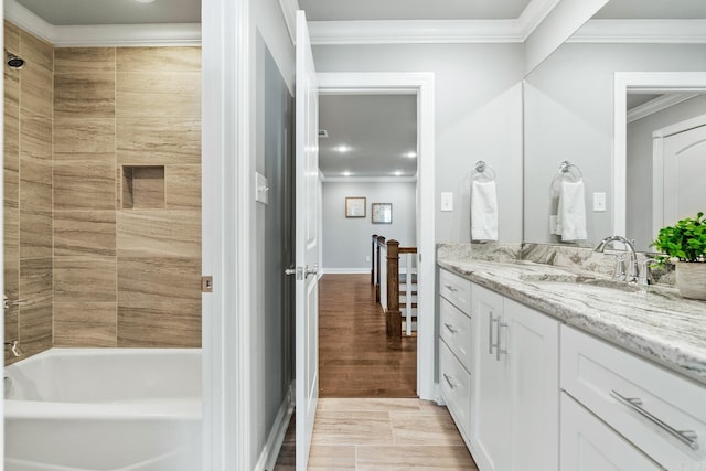 bathroom featuring vanity, shower / tub combination, and crown molding