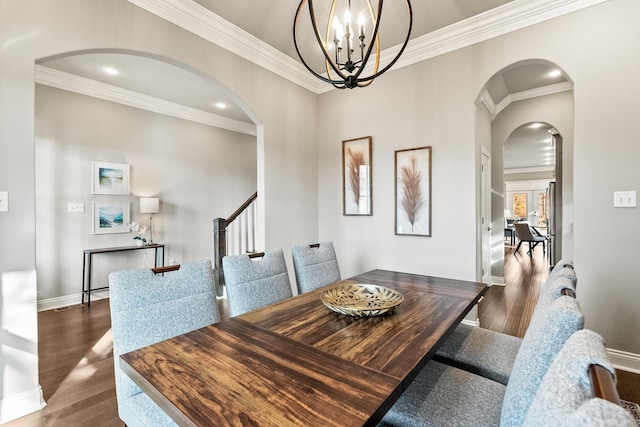 dining room featuring dark hardwood / wood-style flooring, crown molding, and a chandelier