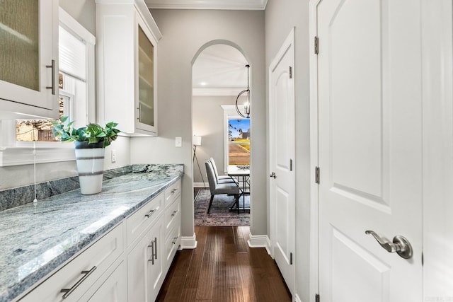 hallway with crown molding and dark hardwood / wood-style floors