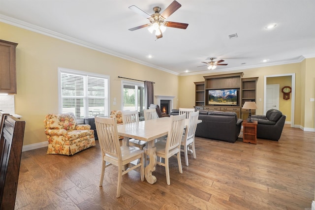 dining area with crown molding, ceiling fan, and hardwood / wood-style floors