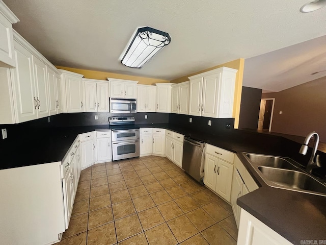 kitchen featuring stainless steel appliances, white cabinets, and sink