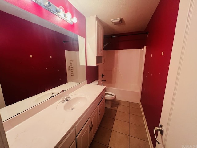 full bathroom featuring toilet, a textured ceiling, tile patterned flooring, shower / bathtub combination, and vanity