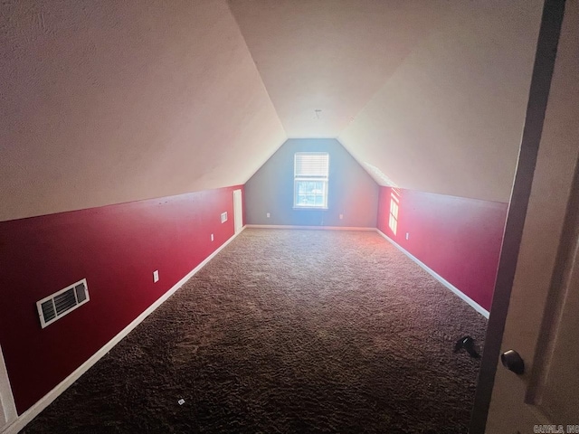 bonus room with lofted ceiling and carpet floors