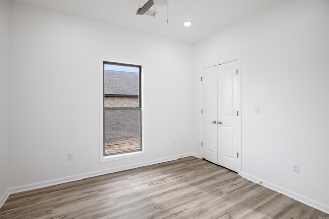 spare room with ceiling fan and light hardwood / wood-style flooring