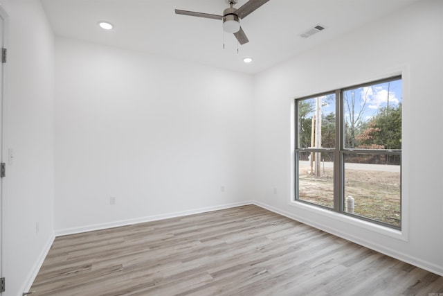 empty room featuring ceiling fan and light hardwood / wood-style floors