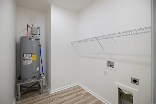 clothes washing area featuring washer hookup, hardwood / wood-style floors, water heater, and electric dryer hookup