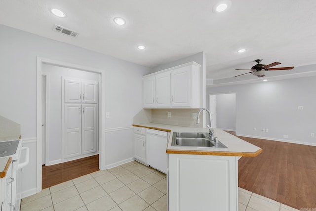 kitchen featuring white appliances, light tile patterned flooring, white cabinets, and kitchen peninsula