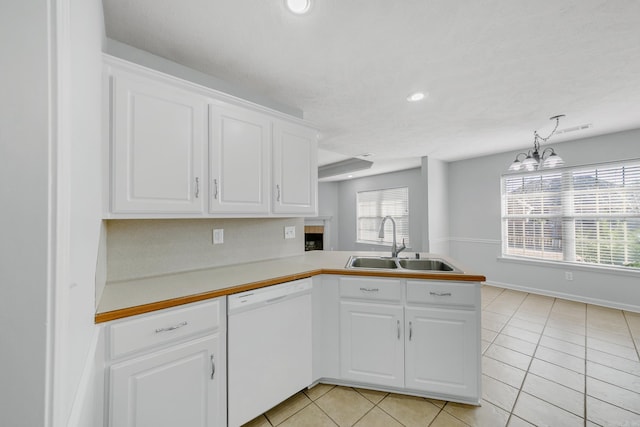 kitchen featuring white dishwasher, white cabinetry, decorative light fixtures, and kitchen peninsula