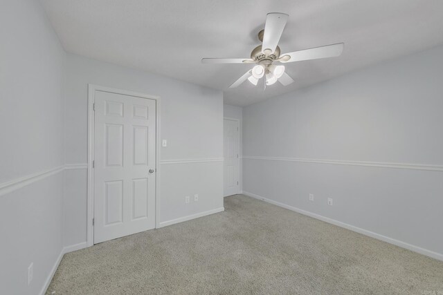 carpeted empty room with ceiling fan