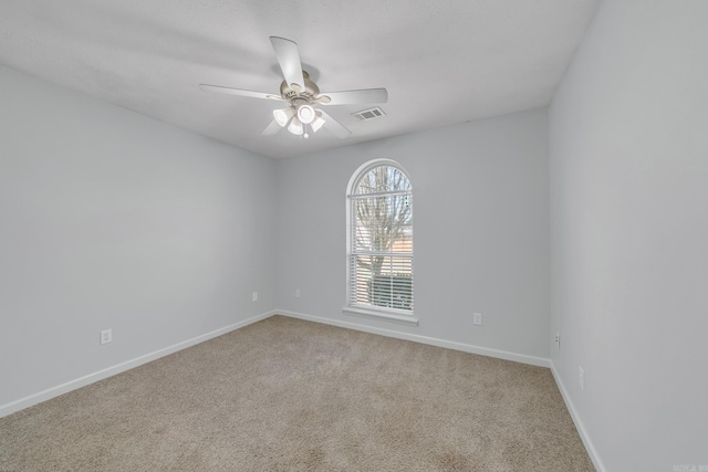 unfurnished room with ceiling fan and carpet flooring