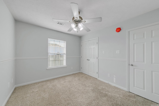 spare room featuring ceiling fan and light carpet