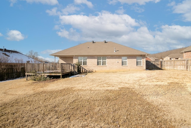 back of property featuring a yard and a deck