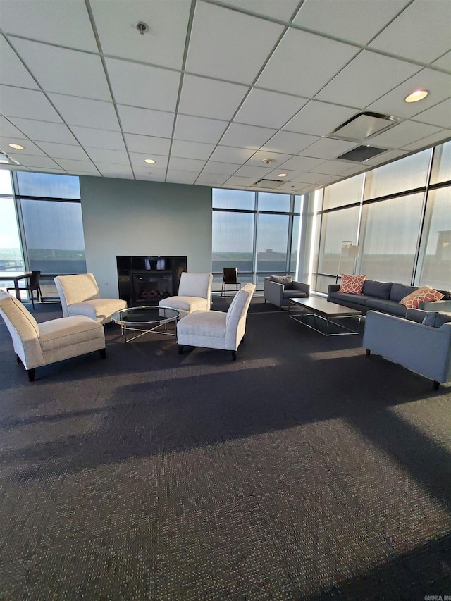 interior space featuring floor to ceiling windows, carpet, and a drop ceiling