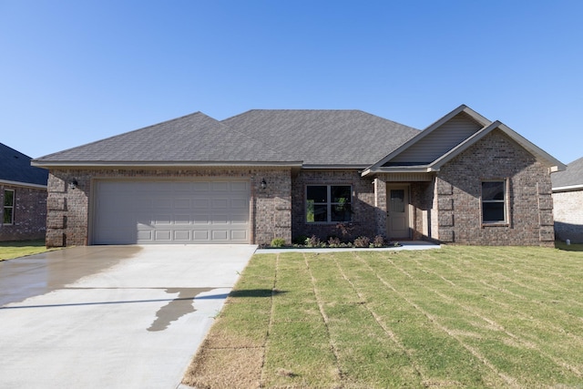 view of front of property with a front yard and a garage