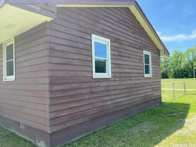 view of side of home featuring a yard