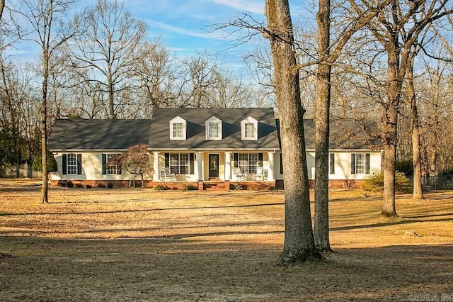 new england style home featuring a front yard