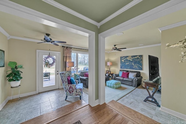 foyer entrance featuring ceiling fan, light wood-type flooring, and crown molding