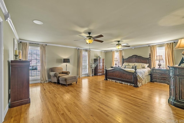 bedroom featuring ornamental molding, ceiling fan, and light hardwood / wood-style flooring