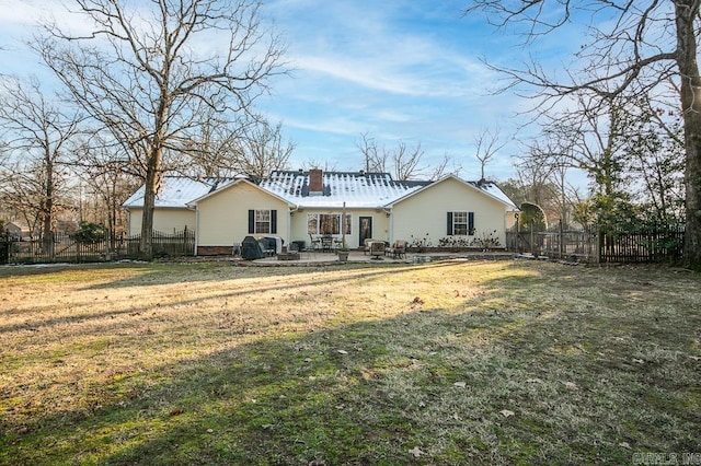 rear view of property with a yard and a patio