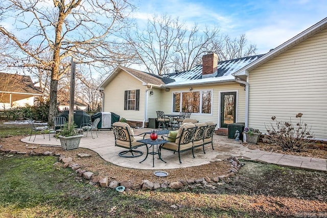 back of house featuring outdoor lounge area and a patio area