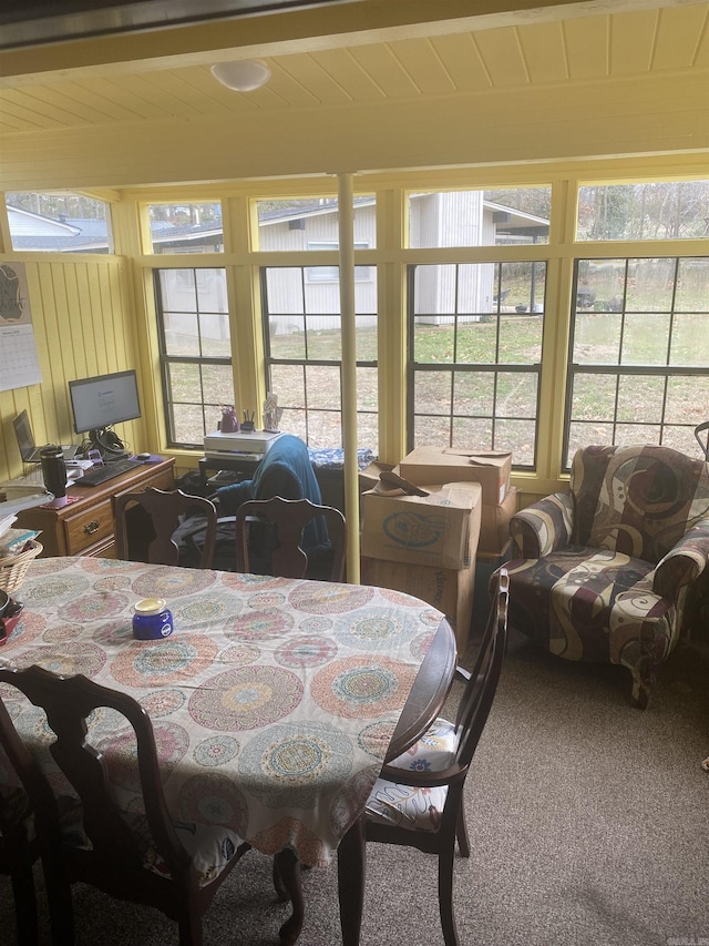 dining area featuring carpet flooring and wooden ceiling