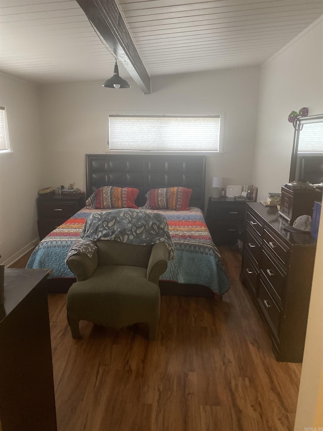 bedroom featuring hardwood / wood-style floors and beam ceiling