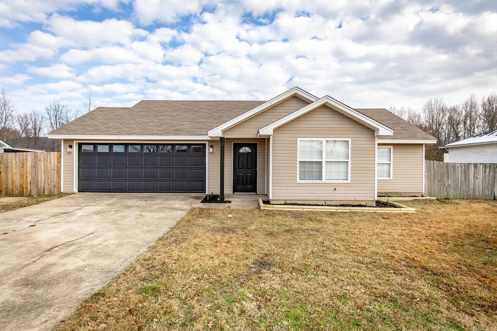 ranch-style home featuring a front yard and a garage