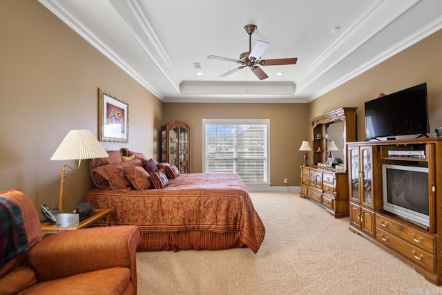 carpeted bedroom featuring ceiling fan, crown molding, and a raised ceiling