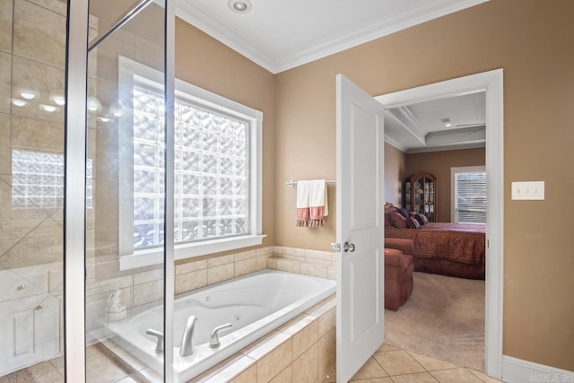 bathroom with a relaxing tiled tub, a wealth of natural light, and crown molding