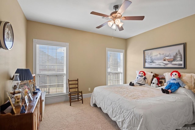 bedroom with ceiling fan and light colored carpet