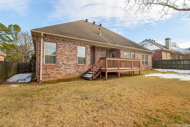 rear view of property with a lawn and a wooden deck