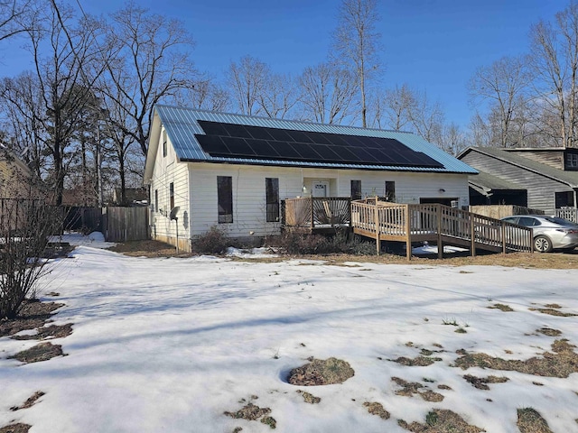 exterior space with a wooden deck and solar panels