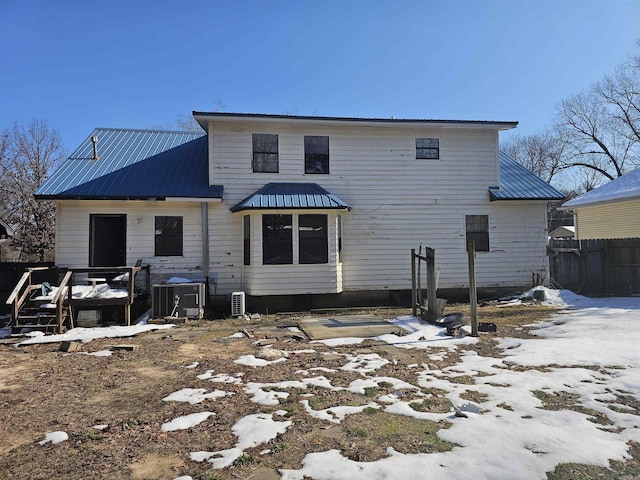 snow covered property featuring central AC unit