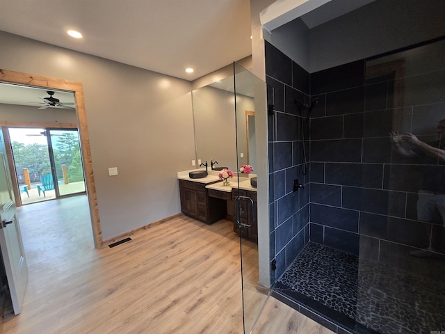 bathroom with ceiling fan, vanity, and wood-type flooring