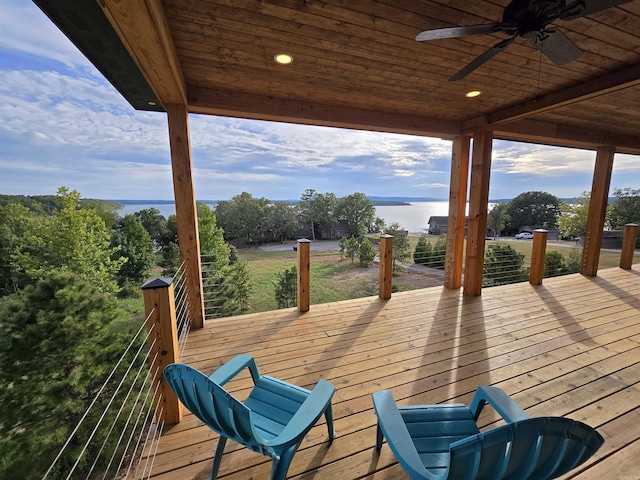 wooden deck with ceiling fan and a water view